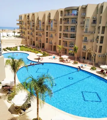 an overhead view of a large swimming pool in front of a building at Luxury apartment With sea view and free beach in Hurghada