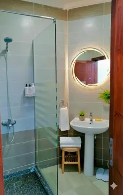 a bathroom with a sink and a glass shower at Luxury apartment With sea view and free beach in Hurghada