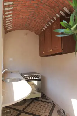 a kitchen with a sink and a counter top at House of Tranquility in Al Aqālitah