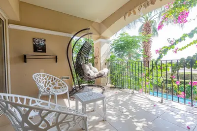 a balcony with two chairs and a table at Ladybird - Veranda Loft in Hurghada