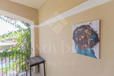 a painting of a woman on a wall next to a window at Ladybird - Veranda Loft in Hurghada