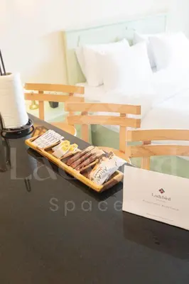 a tray of hot dogs on a table next to a bed at Ladybird - Veranda Loft in Hurghada