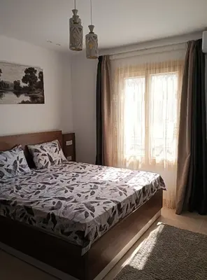 a bedroom with a bed and a window at Tiba Golden in Hurghada