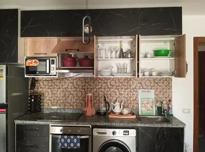 a kitchen with a sink and a dishwasher at Tiba Golden in Hurghada