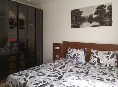 a bedroom with a bed and a painting on the wall at Tiba Golden in Hurghada