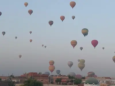 a bunch of hot air balloons flying in the sky at Carter Guesthouse Luxor 5 in ‘Ezbet Abu Ḥabashi