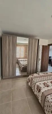 a bedroom with two beds and a large mirror at Tiba golden resort hurghada holiday in Hurghada