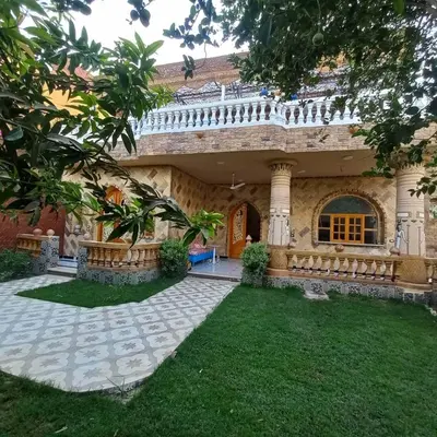 a house with a garden in front of it at Villa Nicole in Luxor