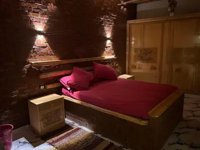 a bedroom with a bed in a brick wall at Djorff studio in Al Aqālitah