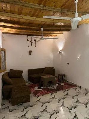 a living room with a couch and a table at Djorff studio in Al Aqālitah