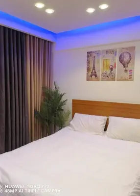 a bedroom with a white bed with a window at Bay View Resort in Hurghada