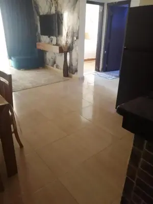 a living room with a tile floor and a blue door at Bay View Resort in Hurghada