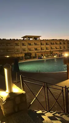 a building with a swimming pool in front of a building at Bay View Resort in Hurghada