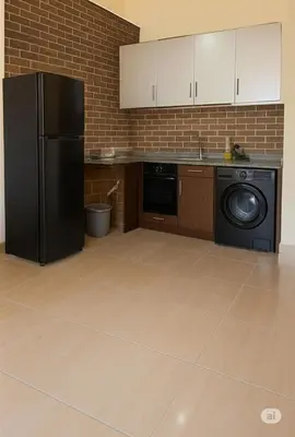 a kitchen with a black refrigerator and a dishwasher at Bay View Resort in Hurghada