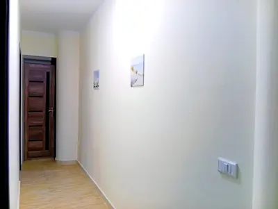 a hallway with a door and two pictures on the wall at شارع عربيه ع البحر مول السلام أمام مستشفي السلام in Hurghada