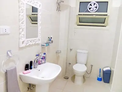 a white bathroom with a sink and a toilet at شارع عربيه ع البحر مول السلام أمام مستشفي السلام in Hurghada