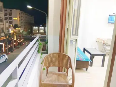 a chair on a balcony with a view of a street at شارع عربيه ع البحر مول السلام أمام مستشفي السلام in Hurghada