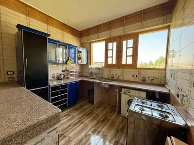 a large kitchen with blue cabinets and a stove at El Fayrouz Guesthouse Luxor in Luxor
