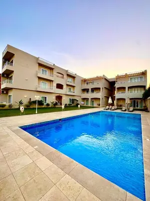 a large swimming pool in front of a building at Royal Nile Villa - Luxury Nile Sky Penthouse 1 in Al Aqālitah