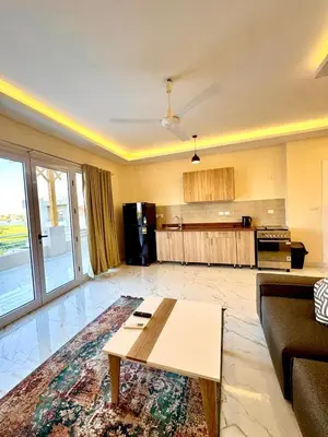 a living room with a couch and a table at Royal Nile Villa - Luxury Nile Sky Penthouse 1 in Al Aqālitah