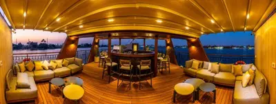 a large deck with couches and a bar on a boat at Sonesta Dahabeya Amirat II - Nile Cruise Ship From Luxor to Aswan 4 nights in Luxor
