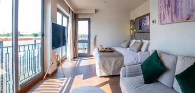 a living room with a couch and a large window at Sonesta Dahabeya Amirat II - Nile Cruise Ship From Luxor to Aswan 4 nights in Luxor