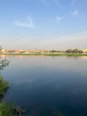 a large body of water with buildings in the background at Elbess For Toursim in Luxor