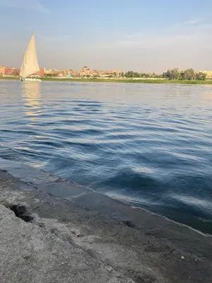 a sail boat on a large body of water at Elbess For Toursim in Luxor