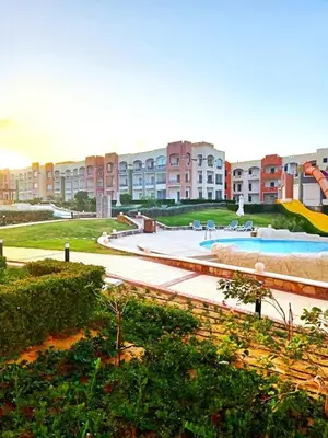 a large apartment complex with a large swimming pool at Oyster Bay Beach Suites in Marsa Alam