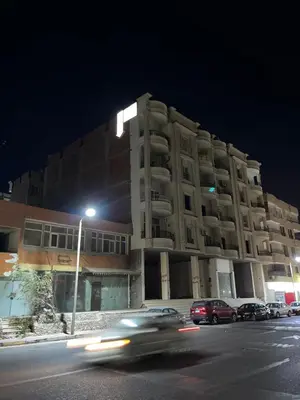 a building on a street at night with cars at Hurghada city apartments 5 in Hurghada