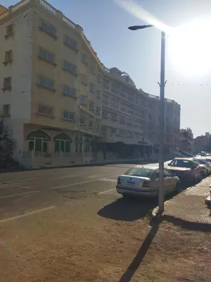 a car parked in front of a large building at Hurghada city apartments 5 in Hurghada