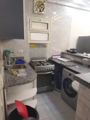 a kitchen with a stove and a washing machine at Hurghada city apartments 5 in Hurghada