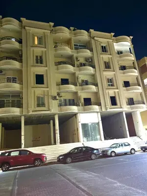 two cars parked in front of a large building at Hurghada city apartments 5 in Hurghada