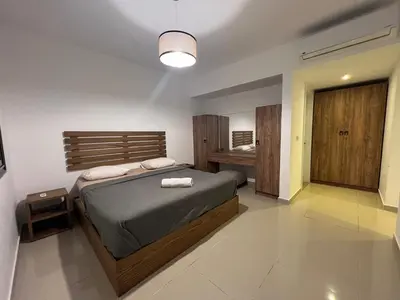 a bedroom with a large bed and a light at Modern Studio in G-Cribs El Gouna in Hurghada