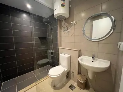 a bathroom with a toilet and a sink and a mirror at Modern Studio in G-Cribs El Gouna in Hurghada