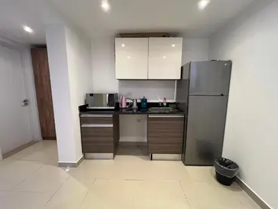 a small kitchen with a stainless steel refrigerator at Modern Studio in G-Cribs El Gouna in Hurghada