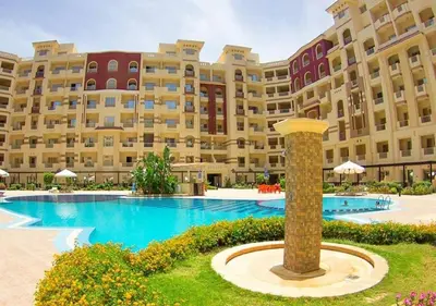 a large apartment building with a large swimming pool at Home 2 Bedroom in Hurghada in Hurghada