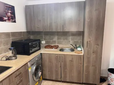 a kitchen with a sink and a microwave at Modern 1bedroom in Hurghada in Hurghada