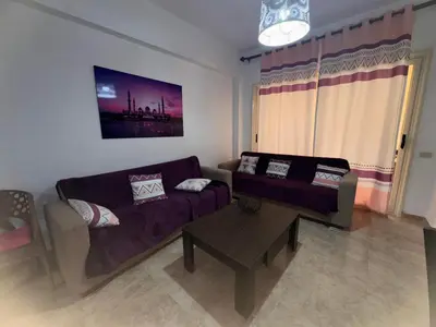 a living room with a couch and a coffee table at Modern 1bedroom in Hurghada in Hurghada