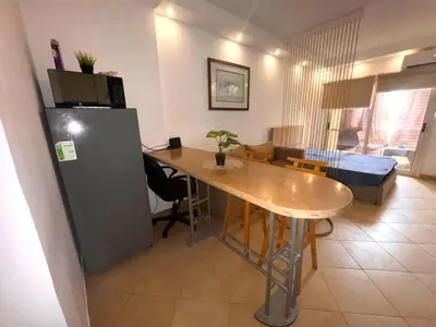a kitchen and living room with a table and a refrigerator at Cozy Studio in Hurghada in Hurghada