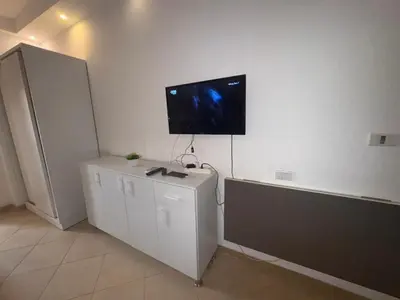 a living room with a tv on a white wall at Cozy Studio in Hurghada in Hurghada