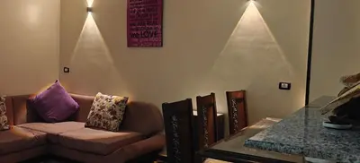 a living room with a couch and a table at Family apartment LUXOR in Jazīrat al ‘Awwāmīyah