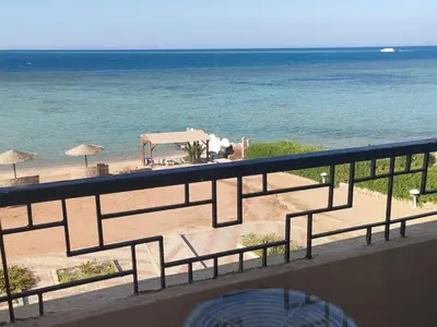 a balcony with a view of the beach and the ocean at Apartment Sama Beach in Hurghada
