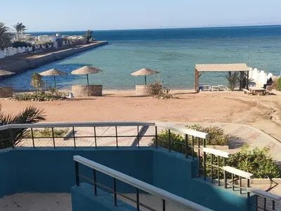 a view of a beach with umbrellas and the ocean at Apartment Sama Beach in Hurghada