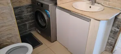 a washer and dryer in a bathroom with a sink at Apartment Sama Beach in Hurghada