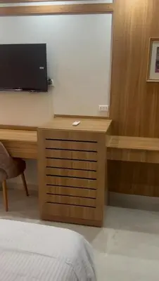 a room with a desk with a television and a bed at Scandic resort in Hurghada