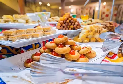a table filled with plates of pastries and other foods at Nile cruise from Luxor to Aswan 4 nights From Aswan to Luxor 3 nights in Luxor