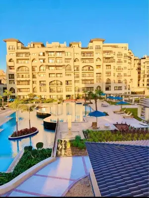 a large building with a pool in front of it at Al-Daw Compound, Al-Mohammadi Square in Hurghada