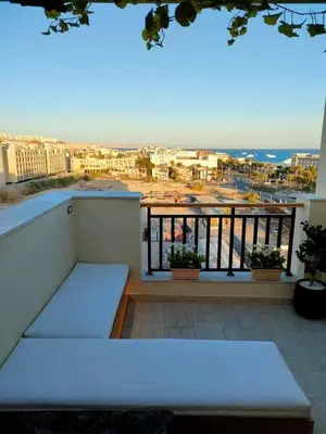 a white bench sitting on top of a balcony at Al-Daw Compound, Al-Mohammadi Square in Hurghada