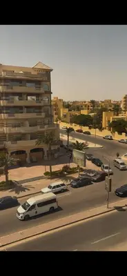 a white van parked in a parking lot next to a building at غرفة فندقية in Hurghada